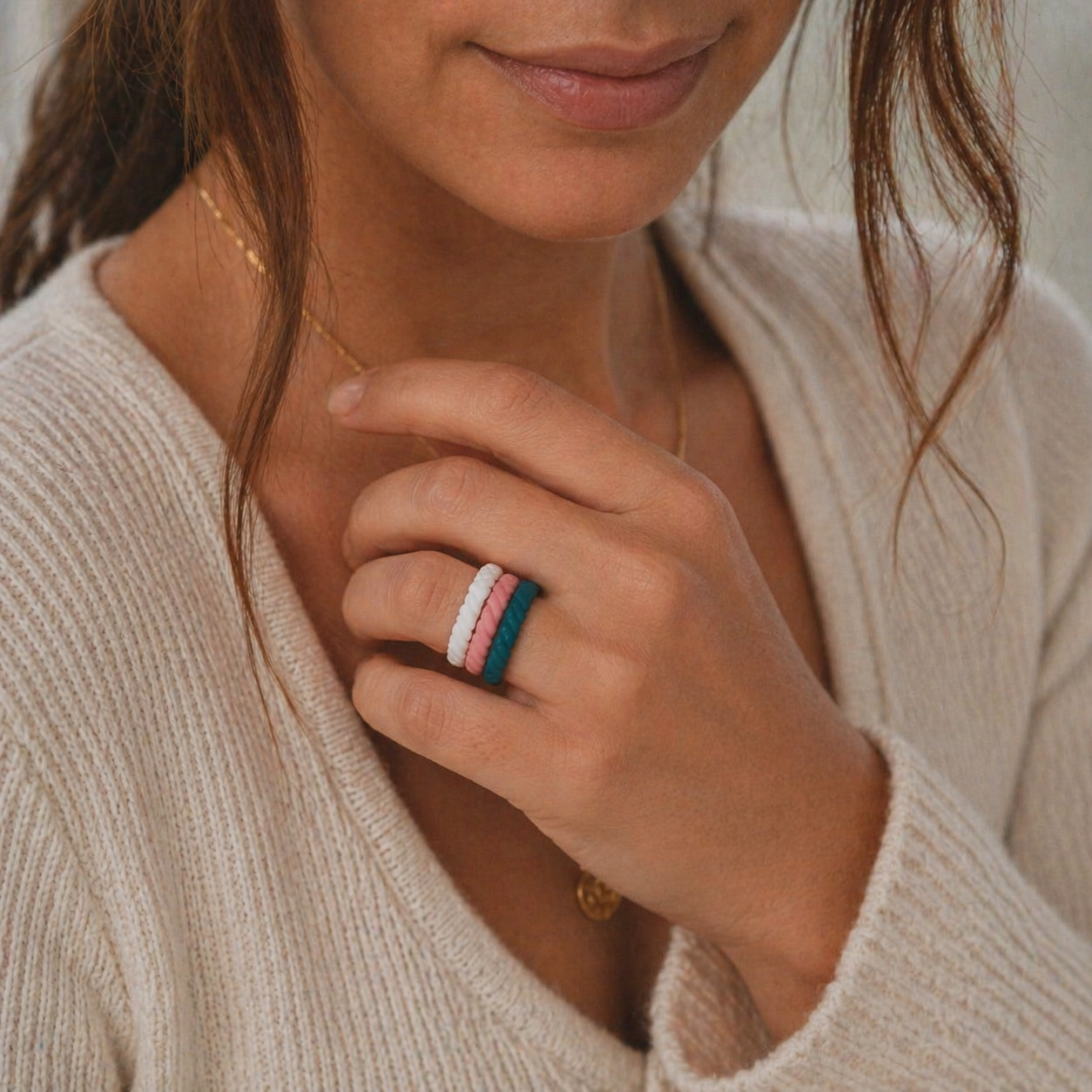 Woman wearing stacked textured silicone rings by Dura Gear Bubbly collection showing colourful flexible rings for gym, work and everyday comfort