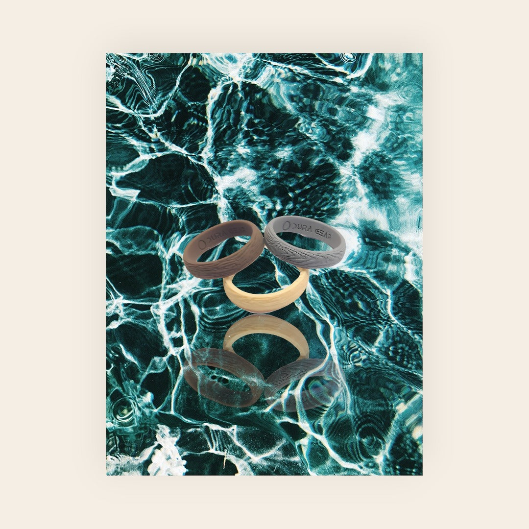 Dura Gear Maple silicone rings displayed on water background showing colour range and design