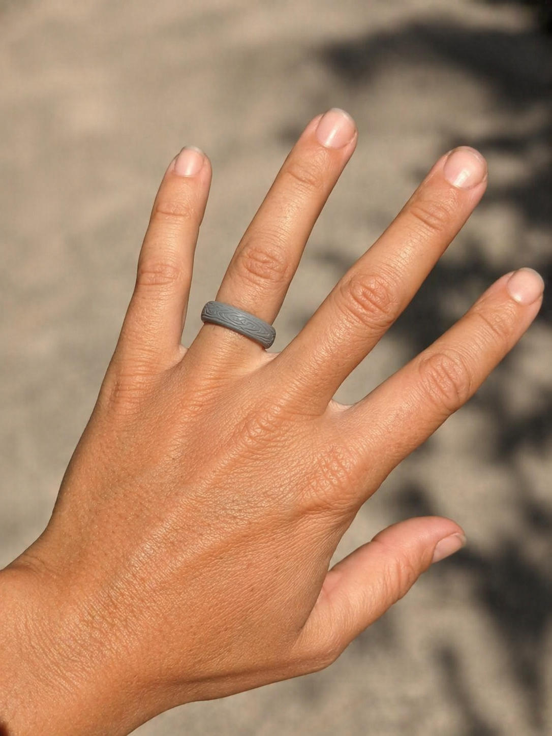 Close up of silicone ring on hand showing fit comfort and design detail